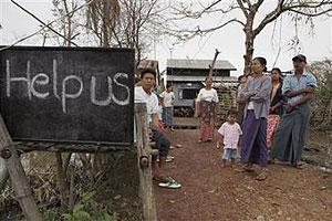 Villagers display a sign saying 'Help Us' on a road near Kundangon, Myanmar